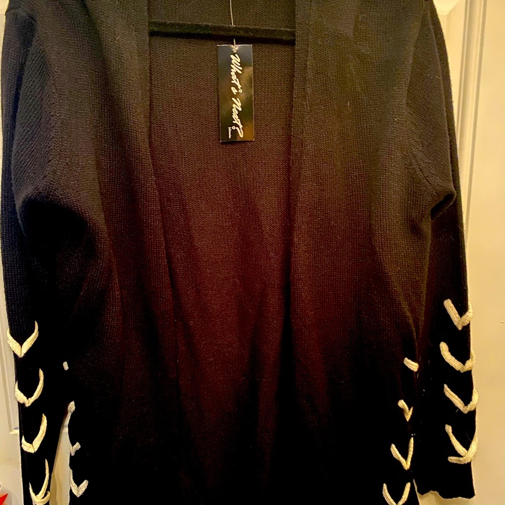 Stylish Black cold weather sweater with white laced sleeves.